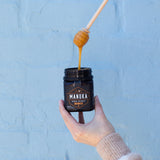 girl holding manuka honey dipper